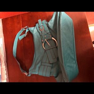 Teal purse with large buckle.